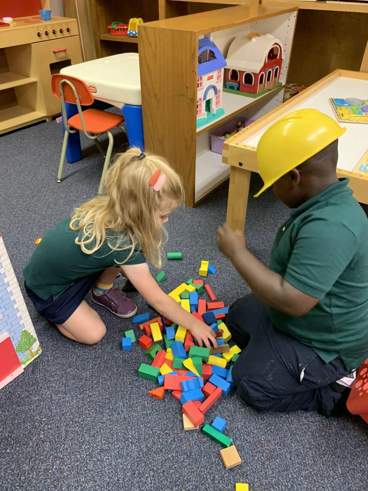 Children exploring hands-on learning centers in a Pre-K classroom