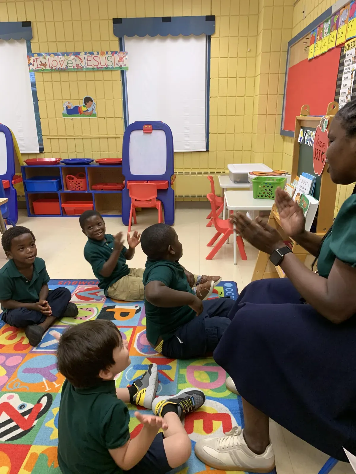 Teacher working with a small group of two-year-olds at a classroom table